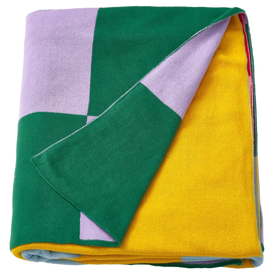 GREJSIMOJS blanket: colourful geometric design, folded with green, yellow, and purple squares.