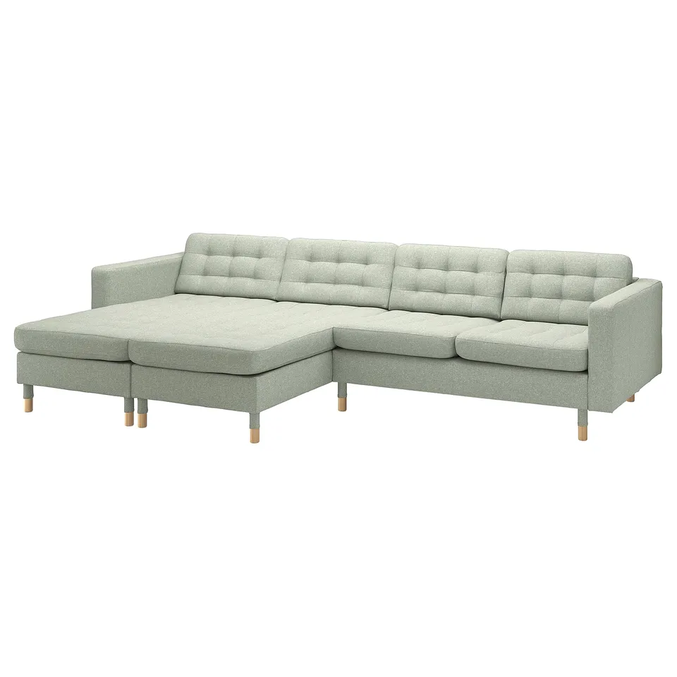 Modern light grey l-shaped sofa with wood legs, tufted seating, and removable cushions.