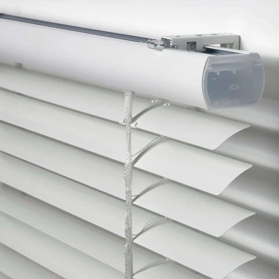 Close-up of sleek, white venetian blinds with unwound cord, showing quality design and modern materials.