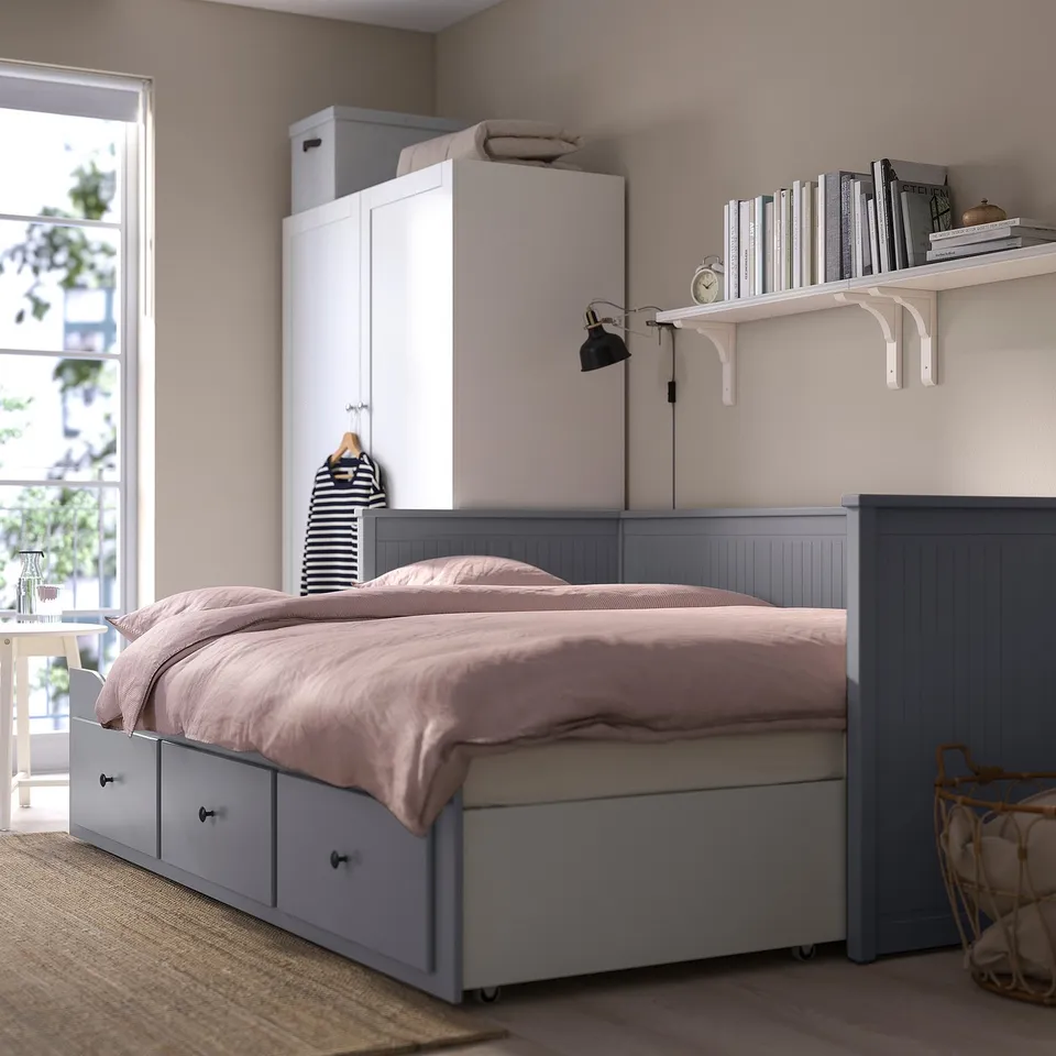 Modern bedroom featuring a HEMNES day-bed with drawers and a pull-out double bed function, ideal for overnight guests.
