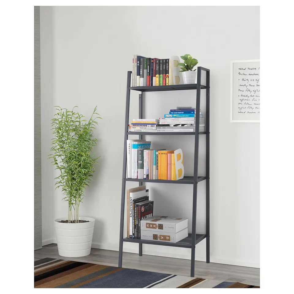 Black bookshelf with books & plant.
