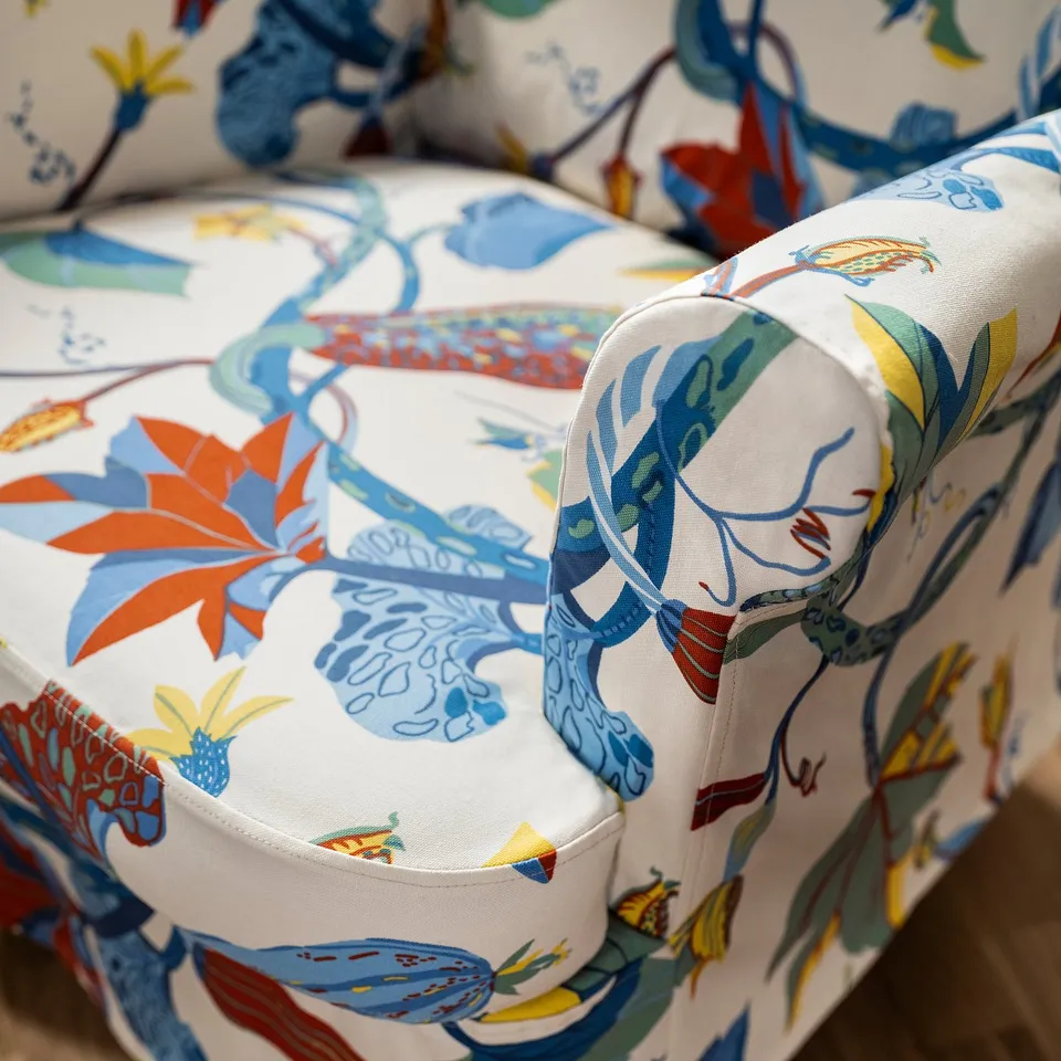 Vibrant, tropical-patterned fabric covers cosy, high-quality armchair.