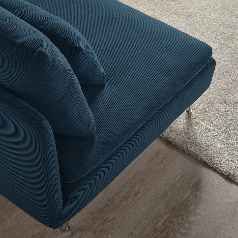 Dark blue SÖDERHAMN sofa on wooden floor and rug, showcasing plush cushions and stylish design.