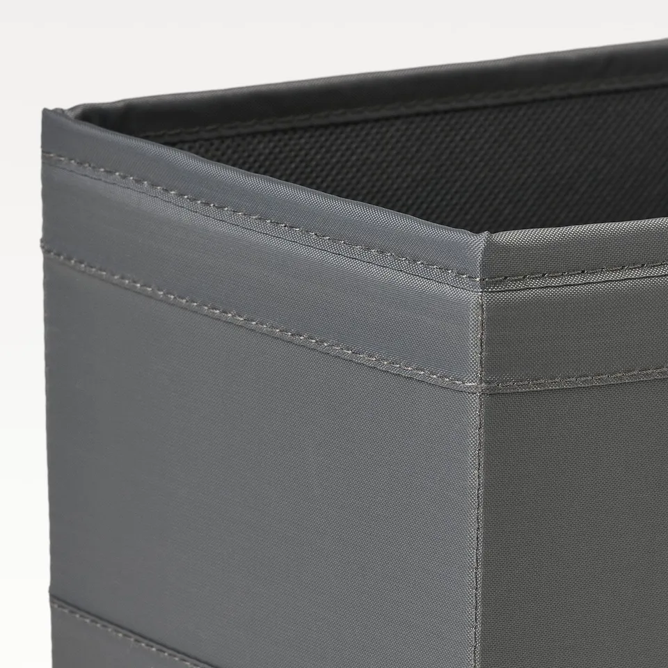 Close-up of sturdy, grey fabric storage box with neat stitching and a mesh top.