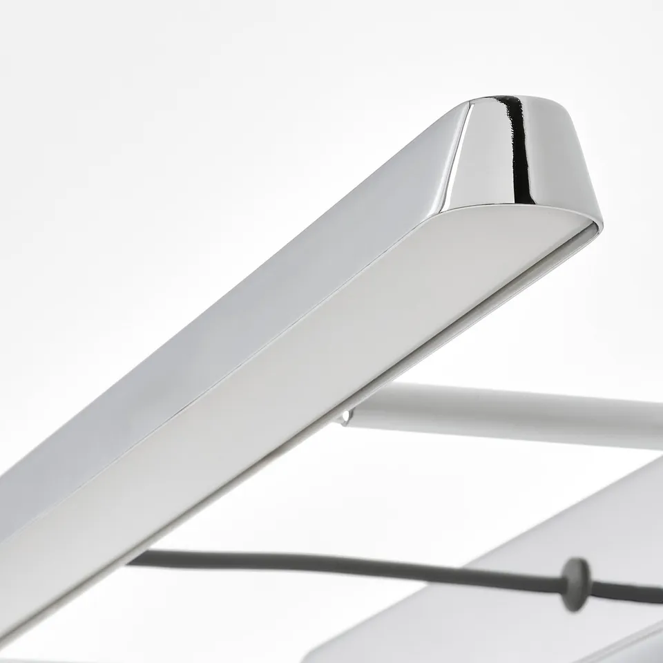 Close-up of modern, sleek chrome-designed bathroom light.