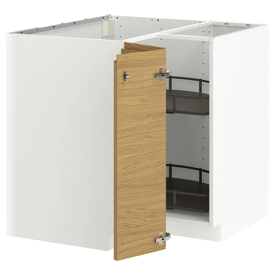 A white METOD kitchen cabinet with a light oak door partially open, revealing adjustable black shelves inside.