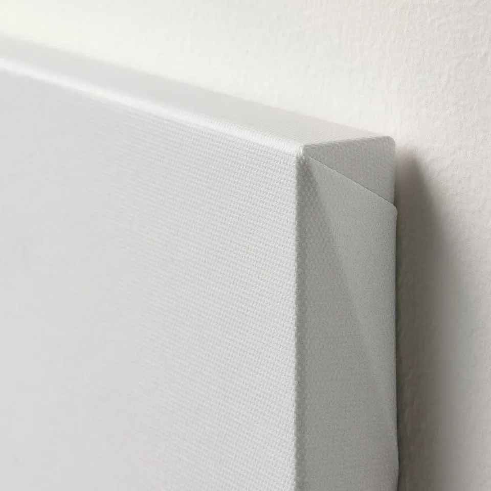 Close-up of canvas arts edge, showing crisp, high-quality wrap around print on a textured, white surface.