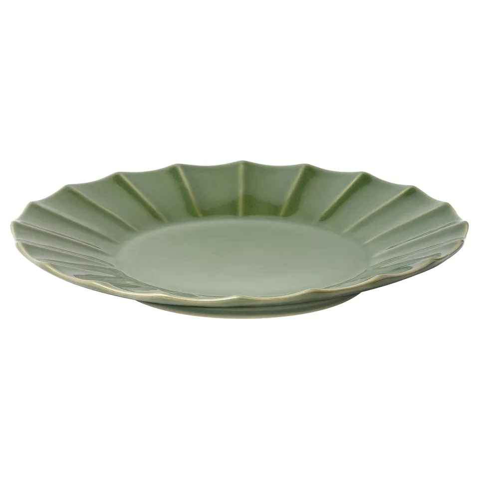 A green glazed stoneware plate with a scalloped edge and textured design by IKEA.