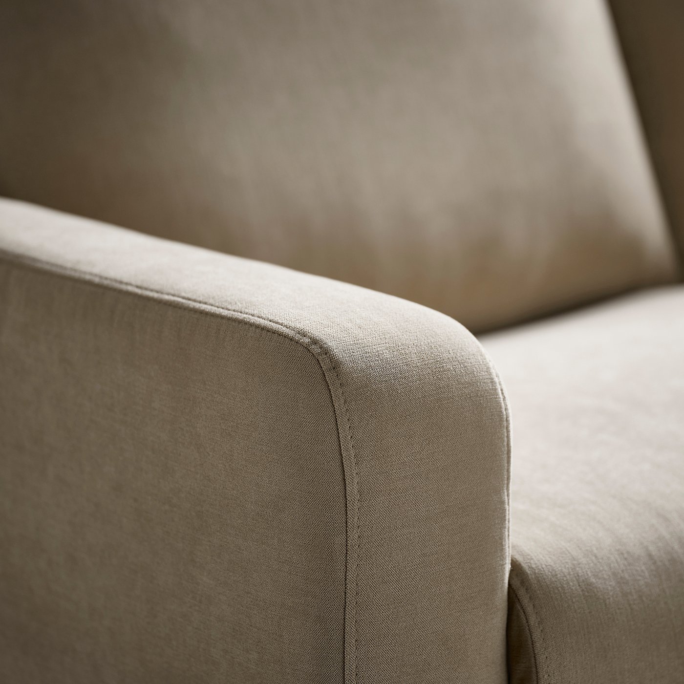 GULLVALLA sofa armrest with soft, textured fabric and smooth edge.