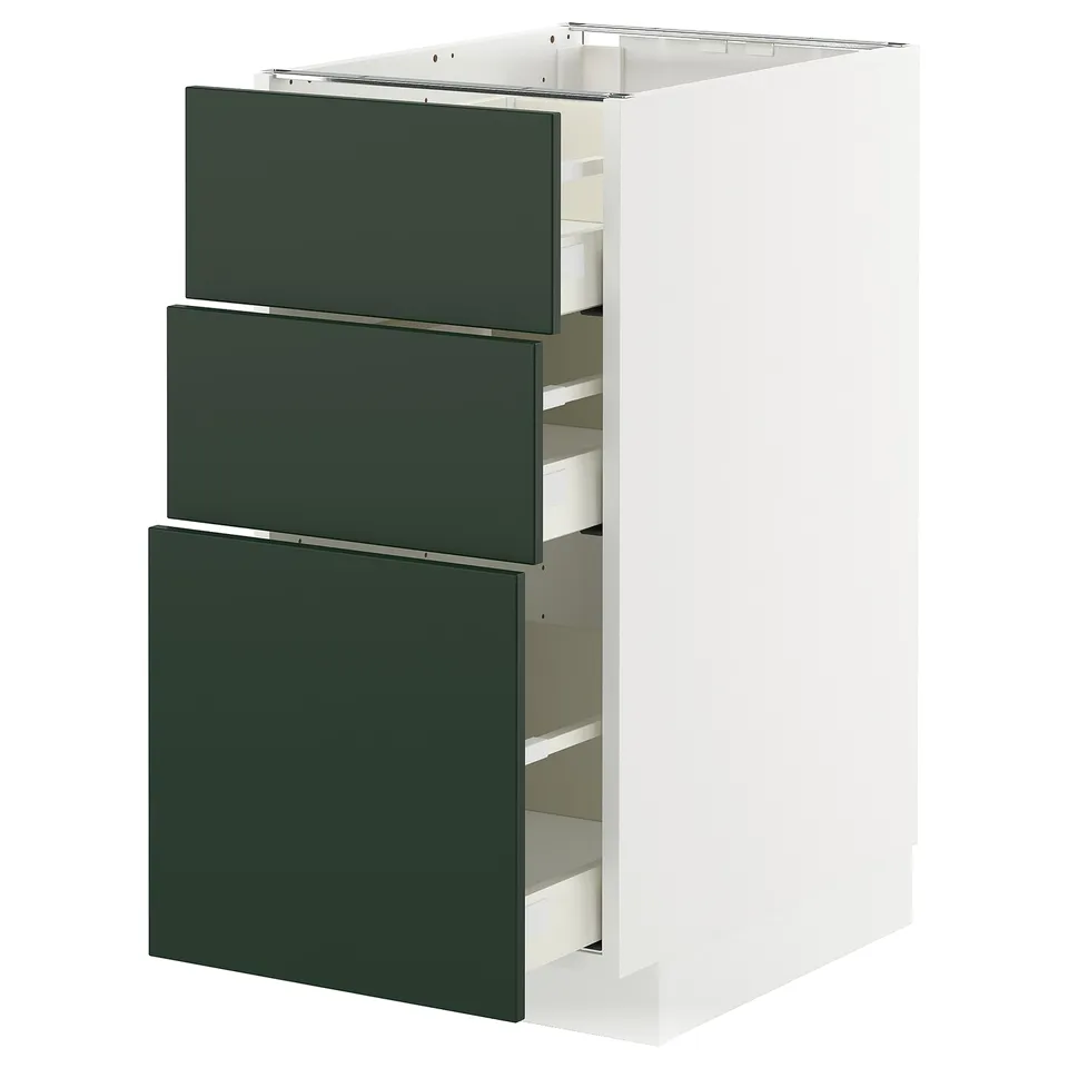 Modern kitchen cabinet in white with three green drawers, sleek design.