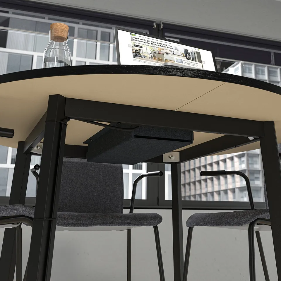 Round conference table with chairs and compartments for meetings.