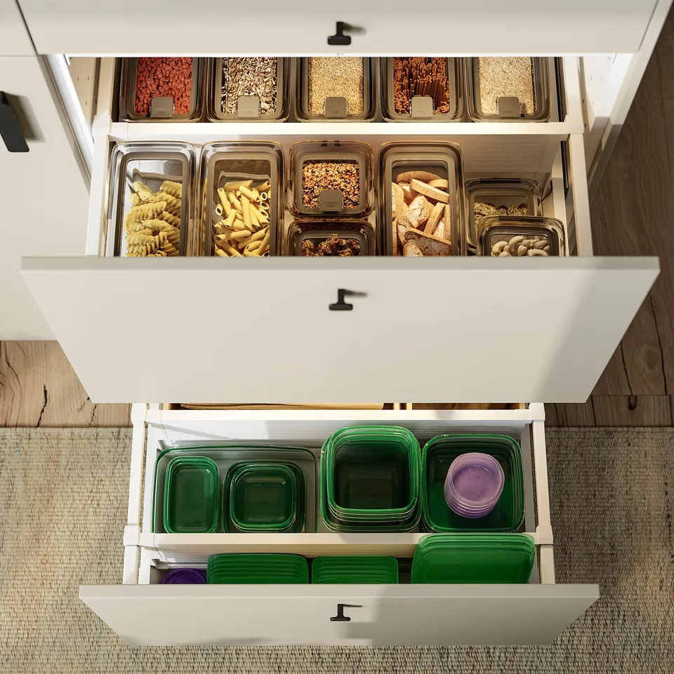 Well-organized kitchen drawers with KORALLVIPPA jars storing dry foods. Transparent for easy access, airtight to preserve freshness.