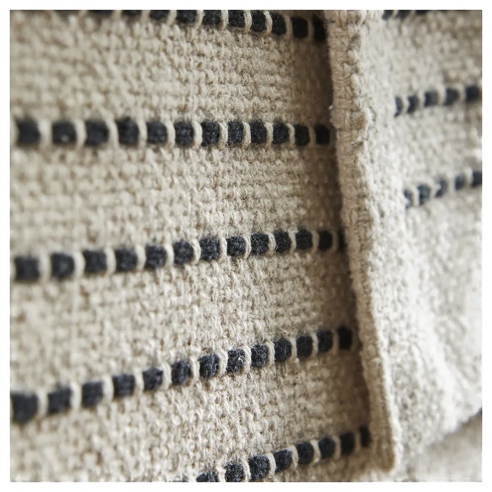 Starrekline natural-beige rug with black stripes, woven cotton.