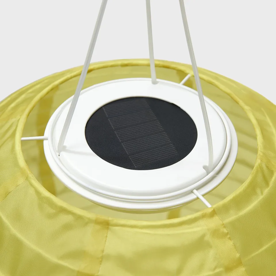 Solar-powered, yellow outdoor lamp with white rim and solar panel, made from recycled materials.