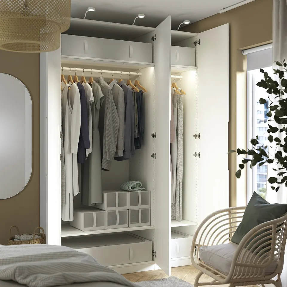 Modern bedroom with open wardrobe, organised clothes, integrated lighting &.