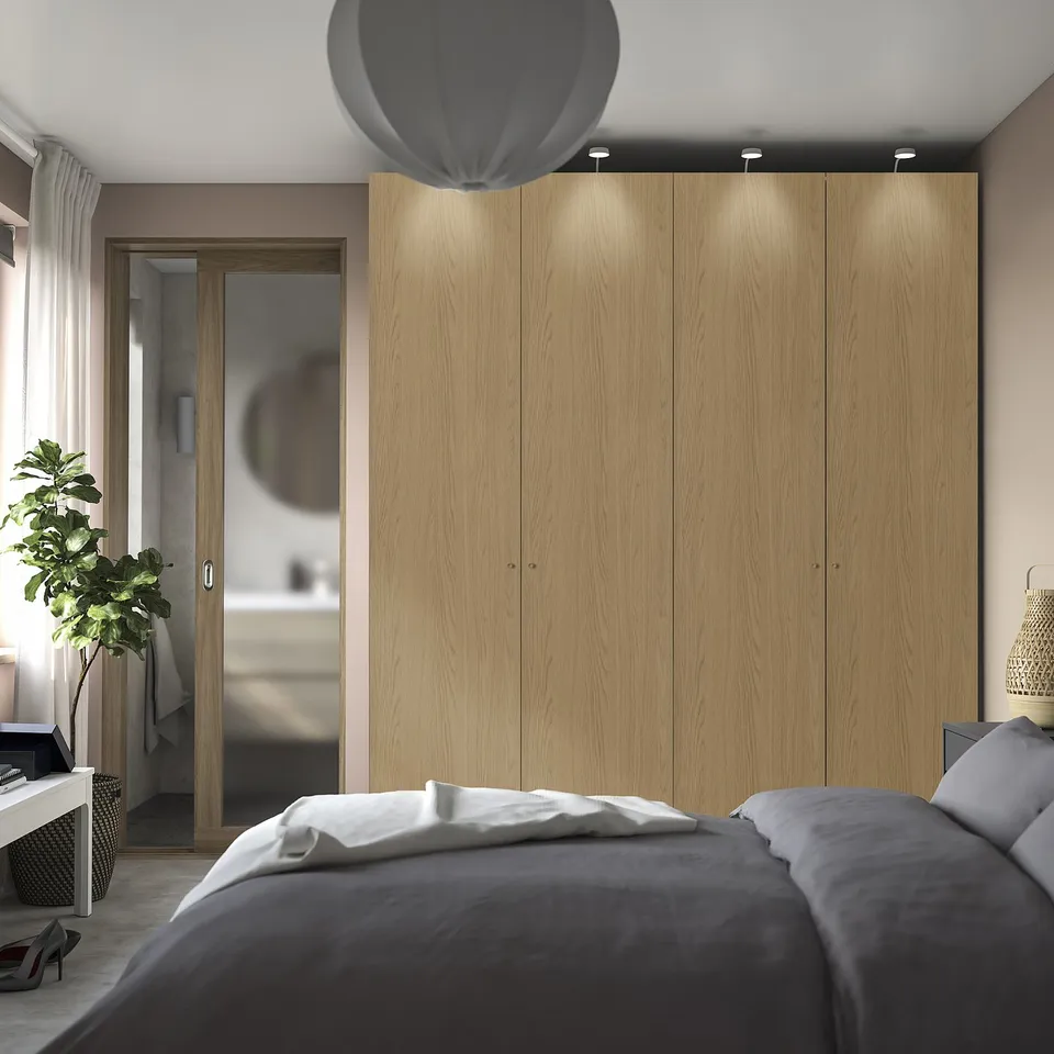 Modern bedroom with large PAX wardrobe, integrated lighting, grey bedding