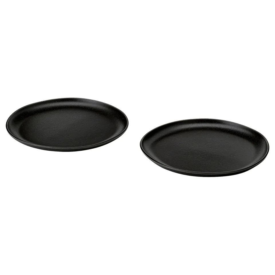 Two black, round, rustic-style plates made of stoneware with a matte surface from the stockholm series.