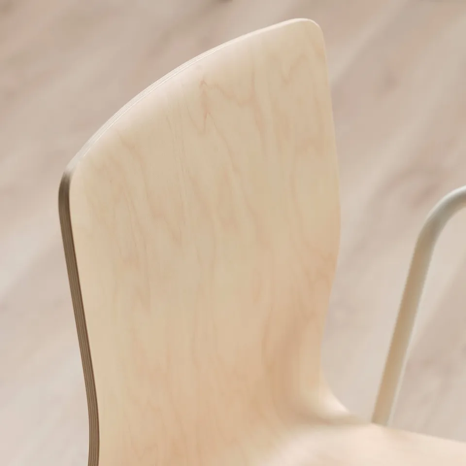 Close-up of a light birch veneer chair back, showcasing its smooth, clean finish and natural grain texture.