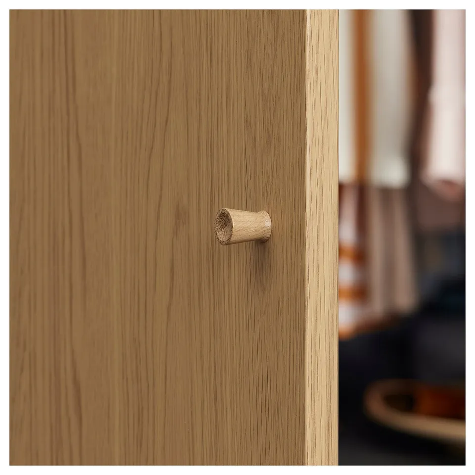 Wooden cabinet with cylindrical handle. Simple, natural design.