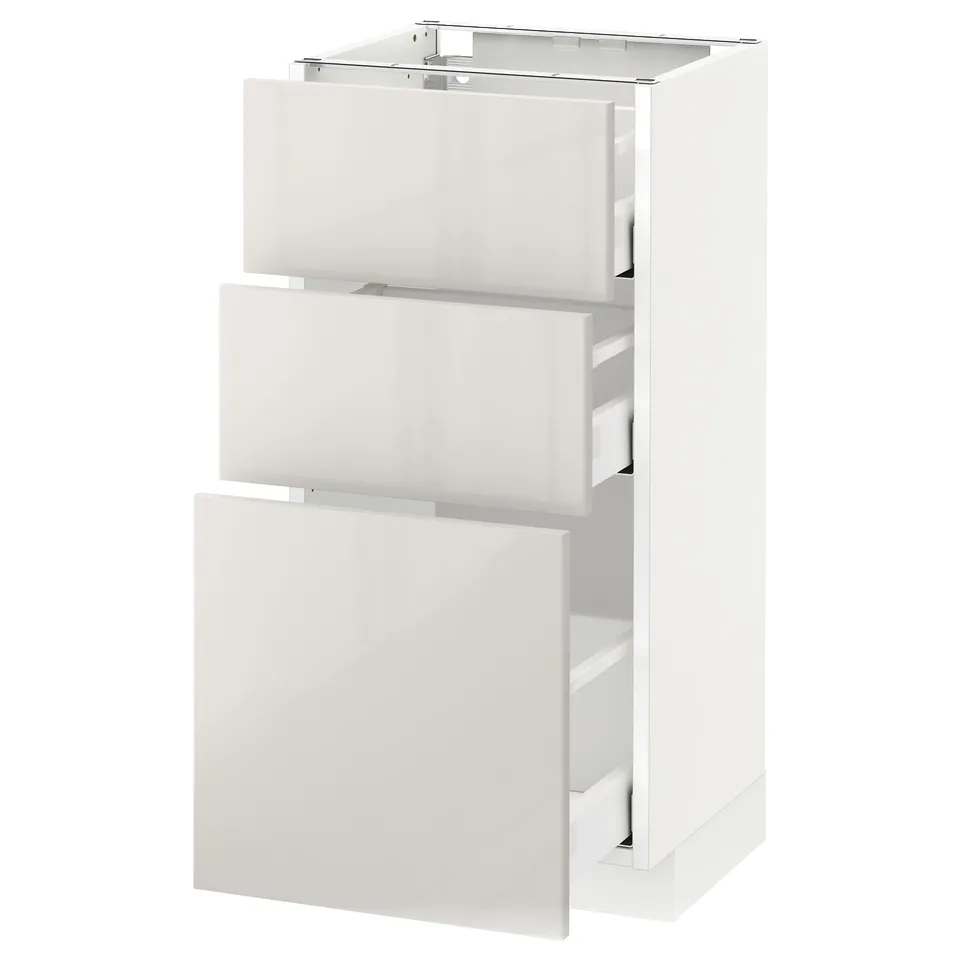 White METOD kitchen unit with glossy drawer fronts.