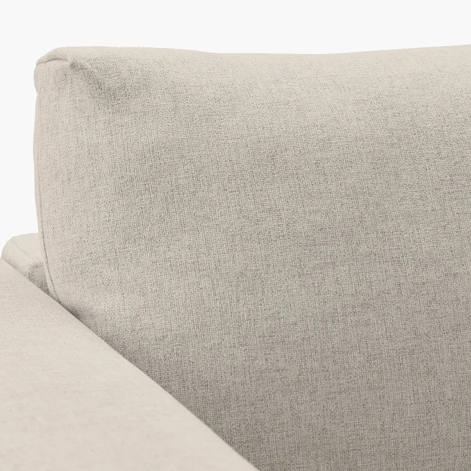 Closeup of VIMLE sofas plush, grey fabric. Soft, high-resilience foam cushion visible. Texture and stitching indicate quality.