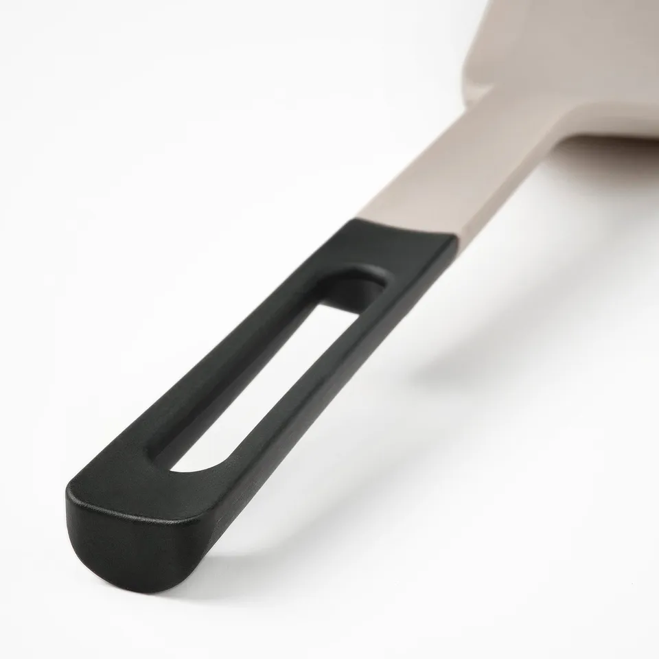 Spatula with ergonomic handle, non-slip silicone edge, designed for flipping and serving.
