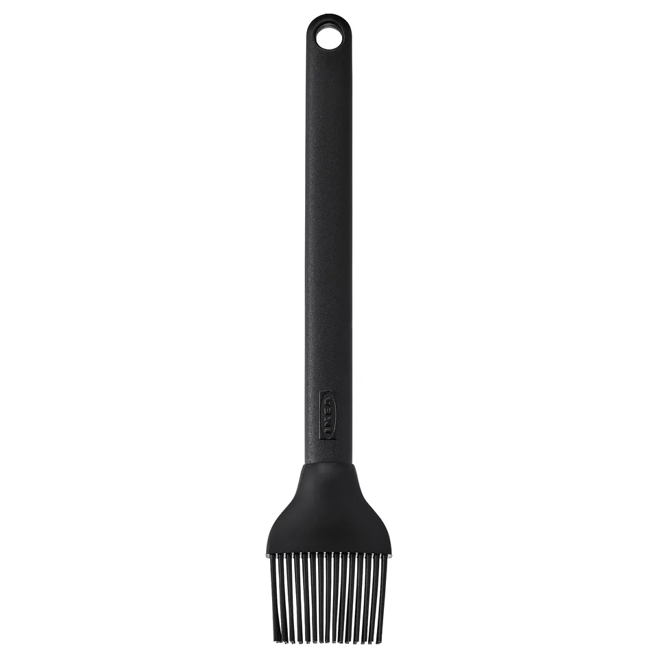 Black grilling brush with silicone bristles and plastic handle. Designed for easy hanging and liquid application.