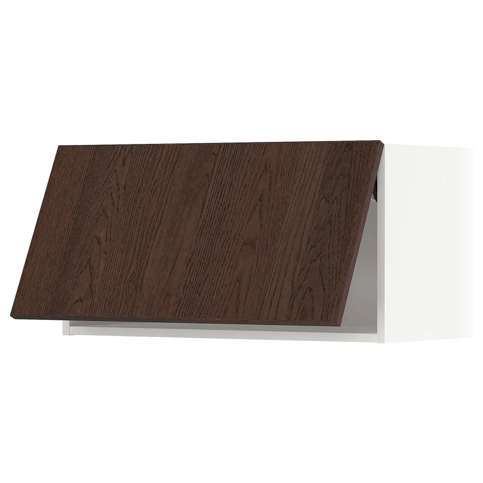 Brown oak METOD kitchen cabinet with white frame and angled top.