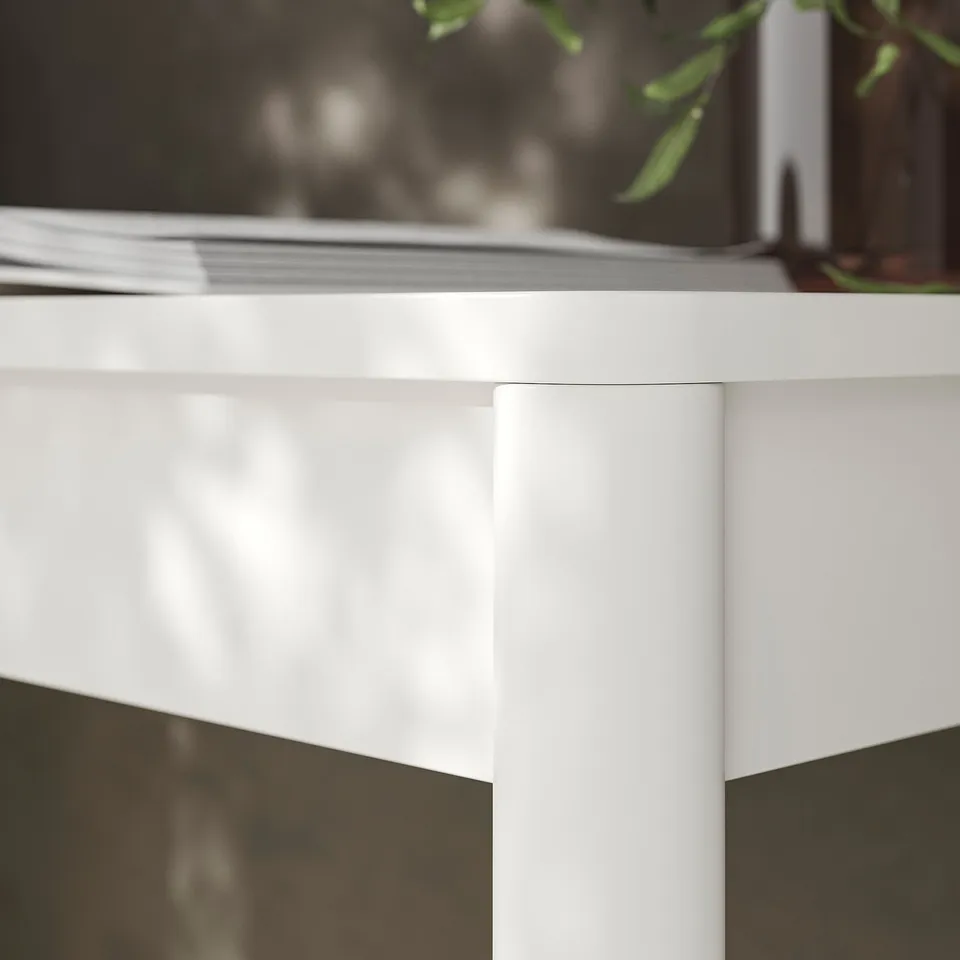 White wall-mounted desk with sleek, glossy finish, sturdy structure, and simple design. Perfect for small spaces, showing quality and modern style.