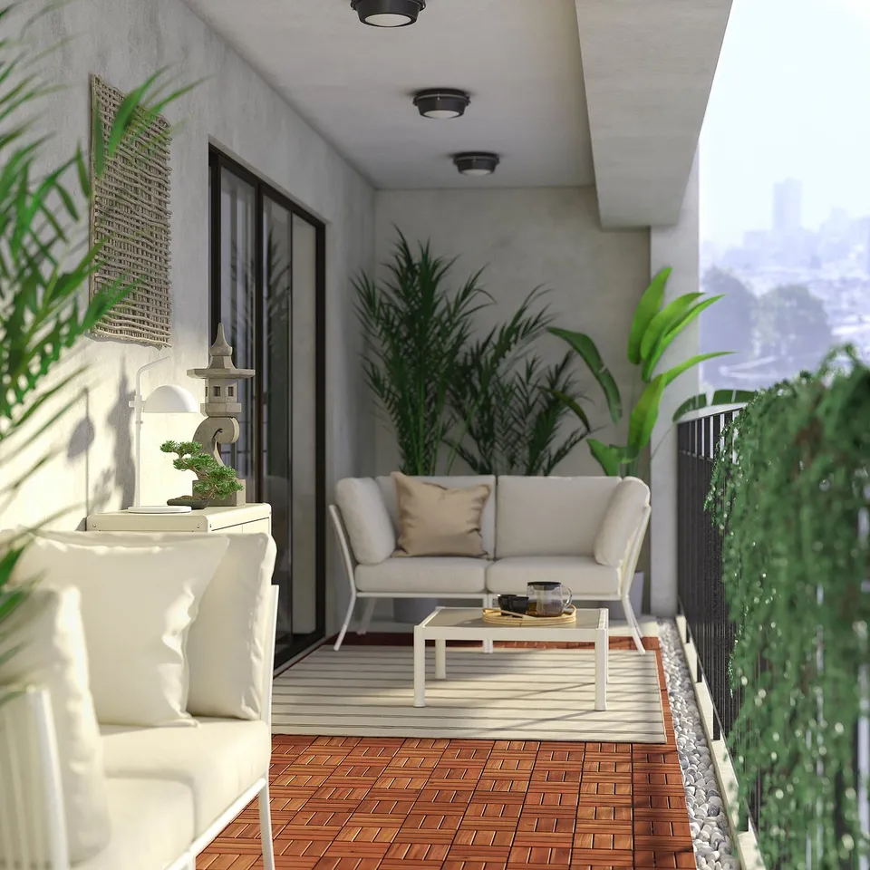 Modern balcony with white sofa, wooden floors, and lush plants, offering a serene city view.