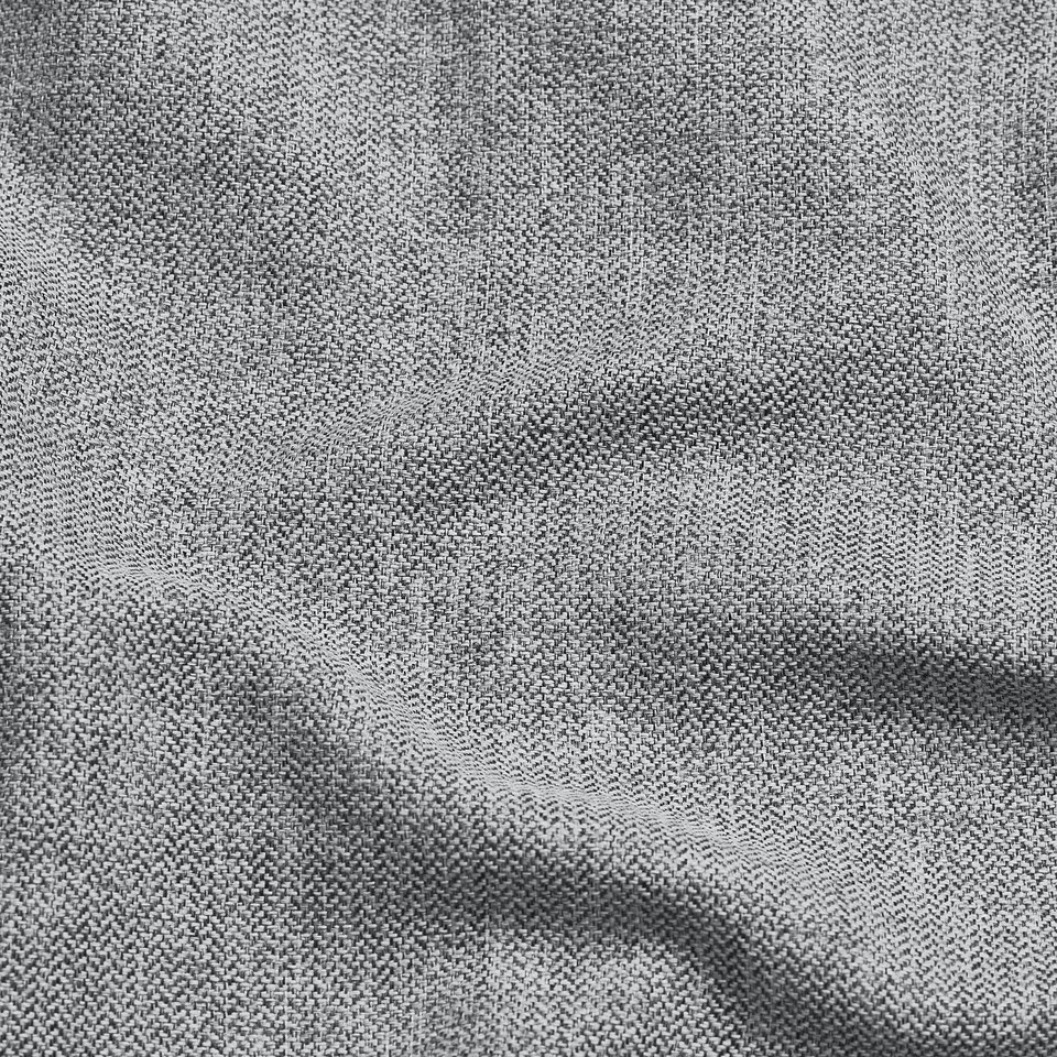 Close-up of a soft, herringbone-patternedfabric with subtle lustre, likely a cover for furniture.