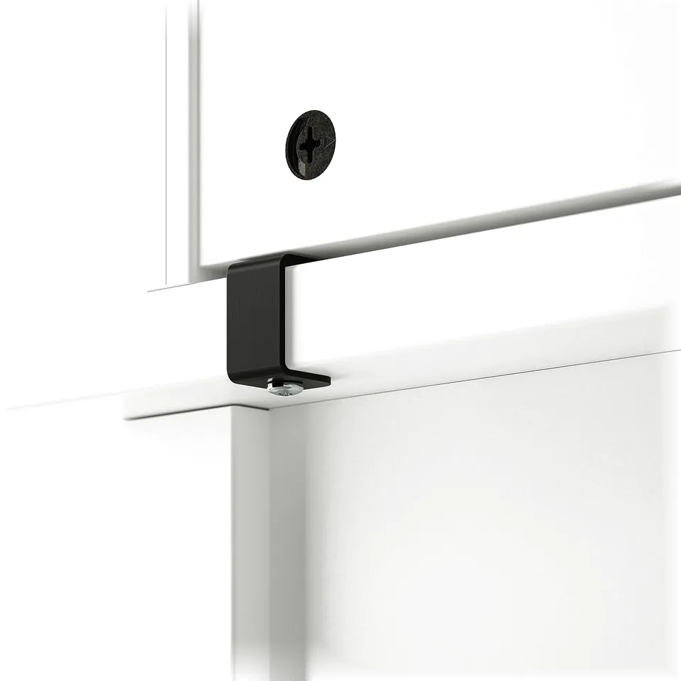Black bracket attaches BRYTNING desk hutch to wall, ensuring stability.