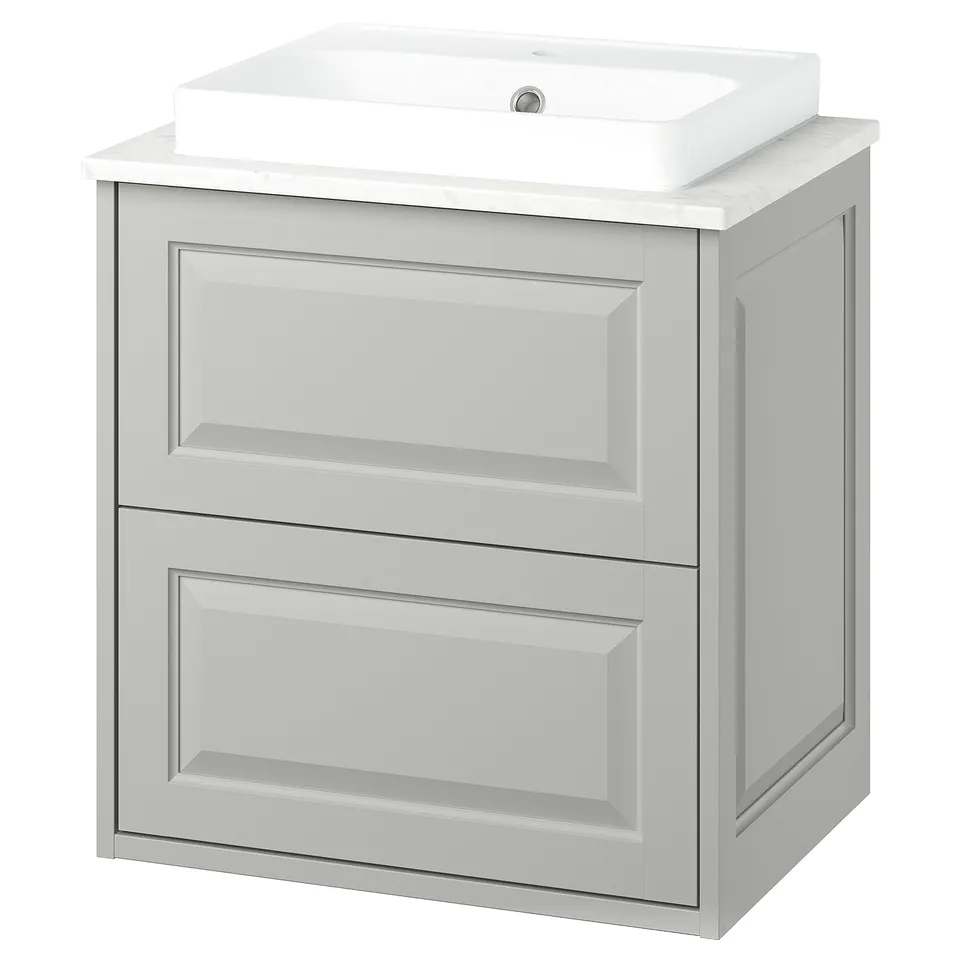 A TÄNNFORSEN light grey bathroom vanity with a sleek design and bevelled panels. It includes a ceramic basin and offers ample storage with drawers.