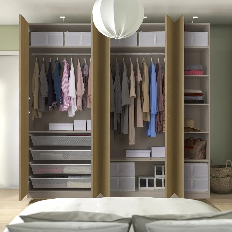 Open wardrobe with clothes hangers, shelves, baskets, and boxes for organised storage.