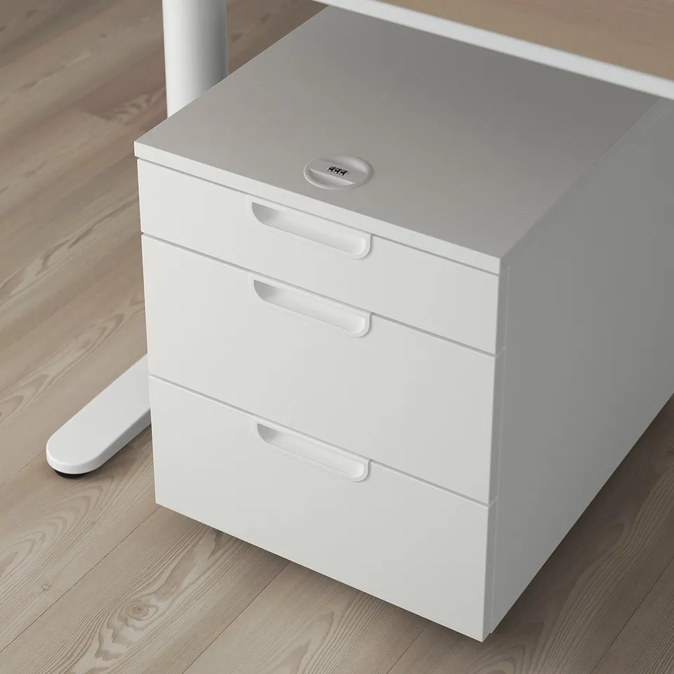 White GALANT filing cabinet with three drawers and a lock, suitable for storing office supplies under a table.