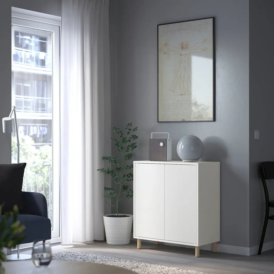 Modern living room with grey walls, large window. EKET storage unit, chair, lamp.