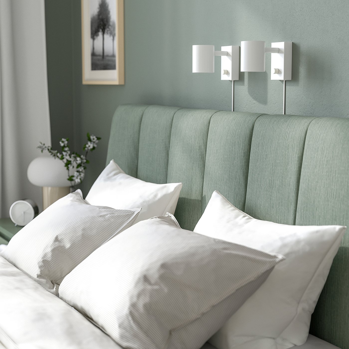 Modern adjustable bed with padded headboard and sconces.