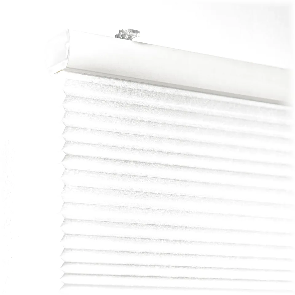 White cellular blind partially rolled down, showing hidden cord and ceiling mounting bracket, offering light filtering and privacy.