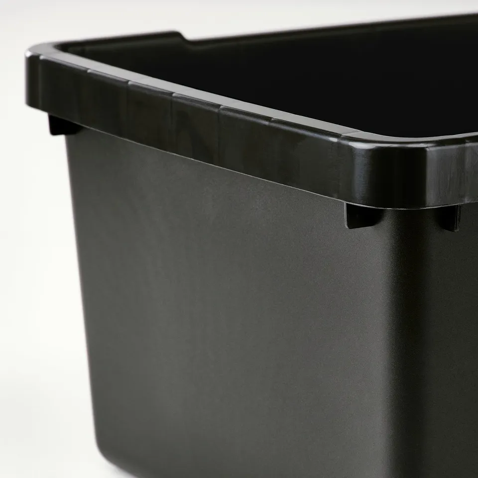 Black storage bin with ridged grip, close-up.