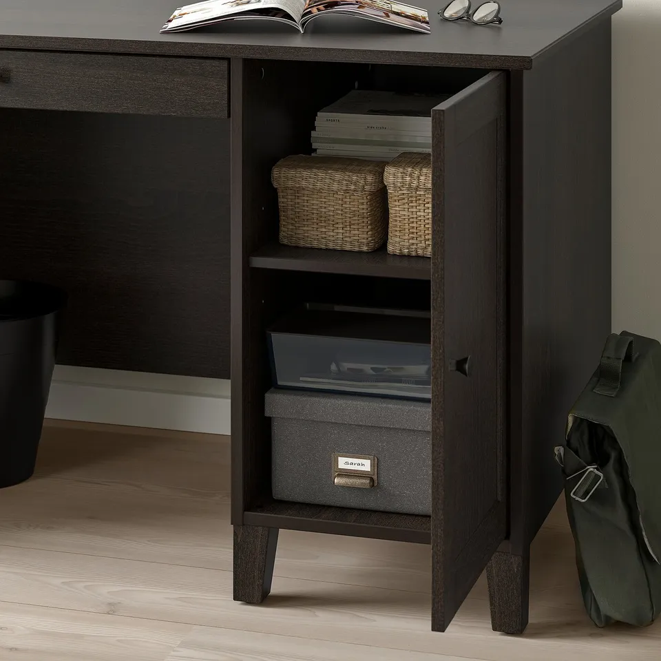 Desk with open door showing storage baskets and a labelled box for organising papers. Soft-closing feature visible.