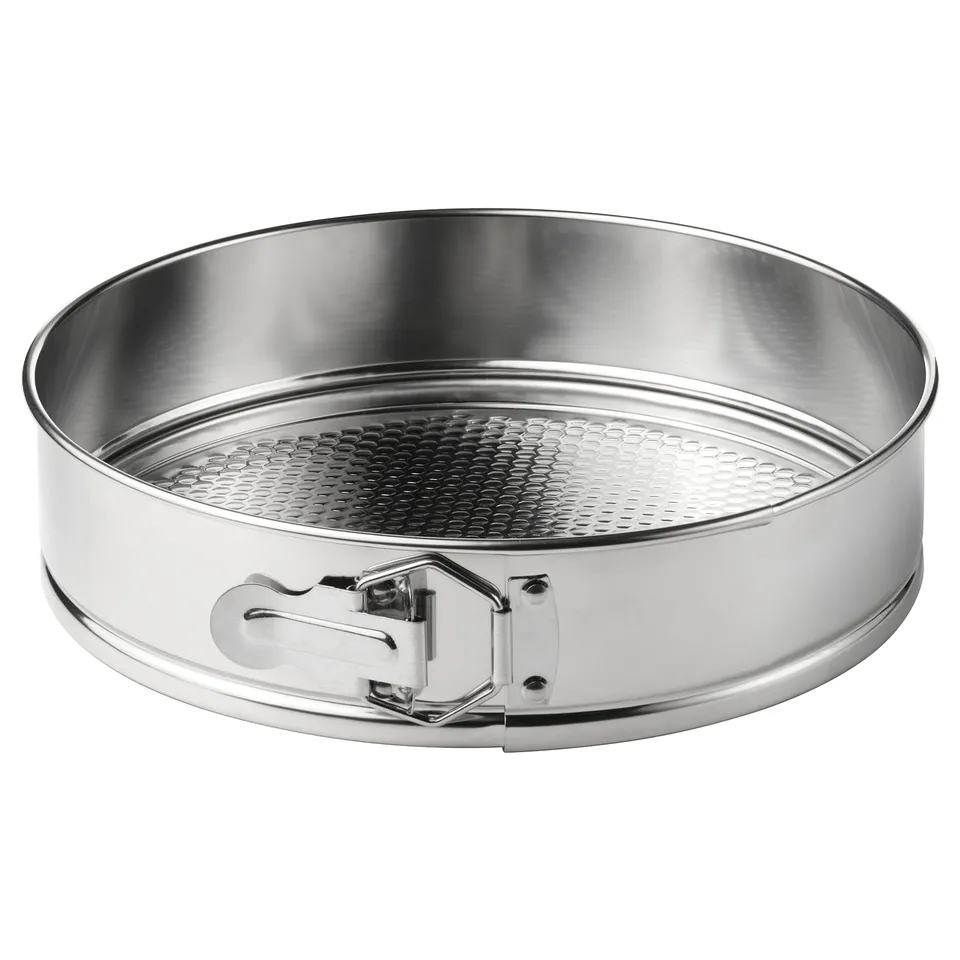 A round stainless steel springform pan with perforated base and side handles.