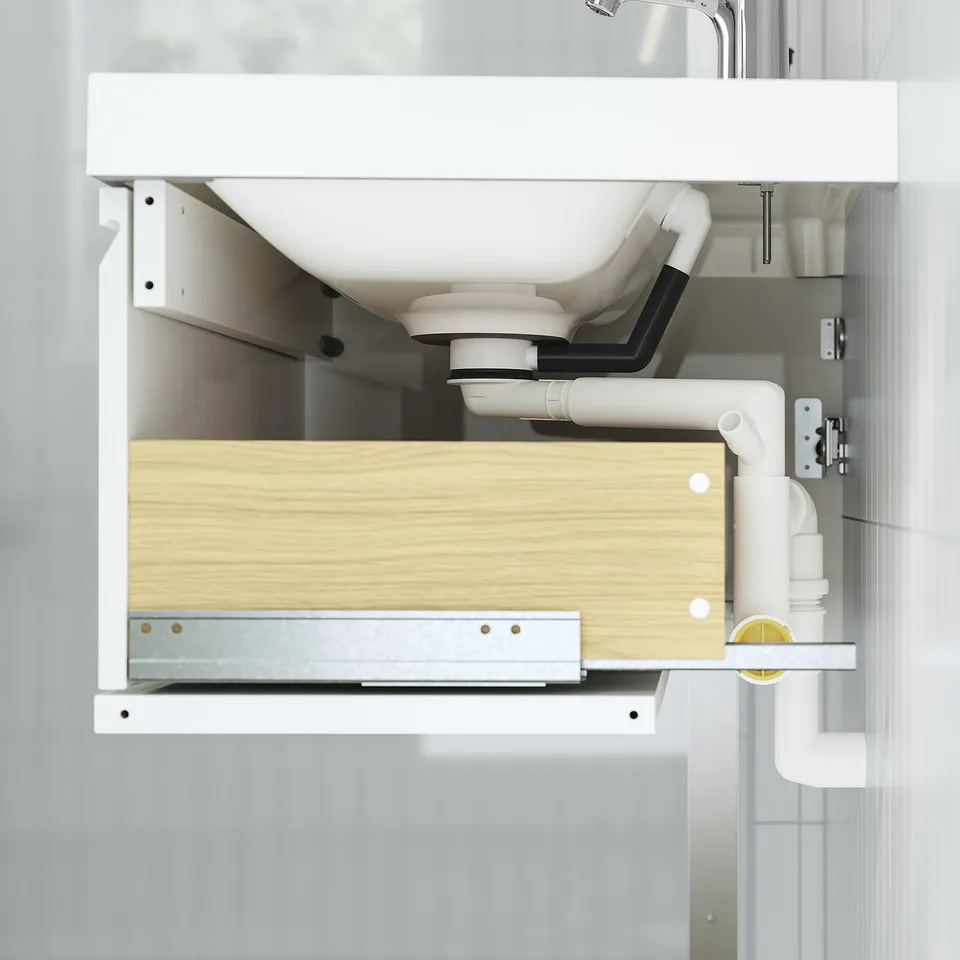 Modern bathroom cabinet with integrated drawer, minimalist handles, displaying plumbing, wall-mounted, oak finish.