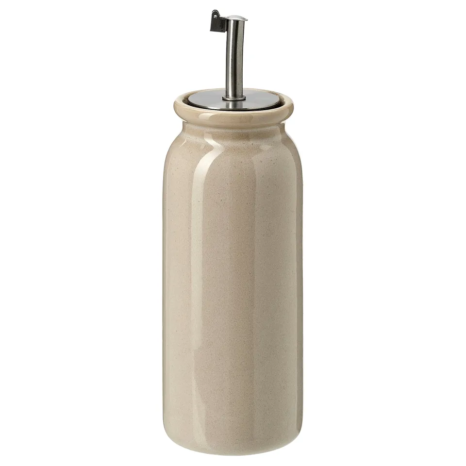 BRUGDHAJ, beige stoneware oil/vinegar dispenser, stainless steel lid, rustic glazed surface.