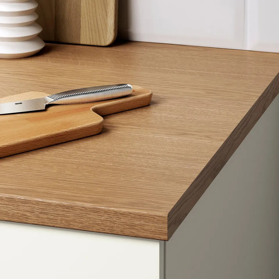 Wooden kitchen counter with integrated knife holder and wooden cutting board. Part of a modular kitchen set.