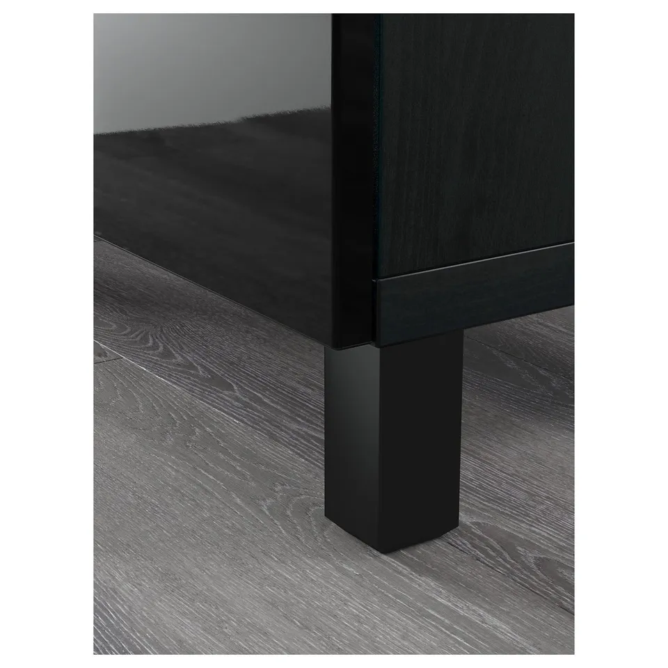 BESTÅ black sideboard with glass door on wood floors.