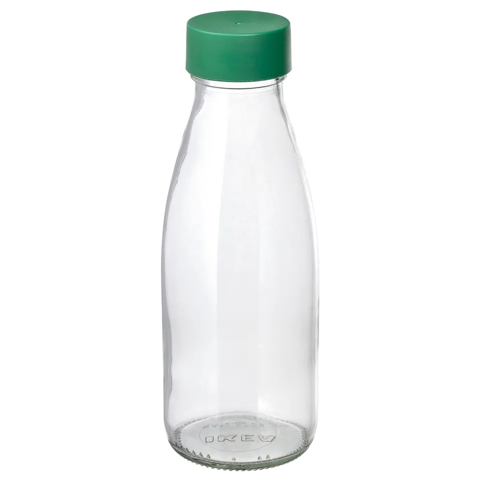 A clear glass SPARTANSK bottle with green lid, designed for travel, reusable.