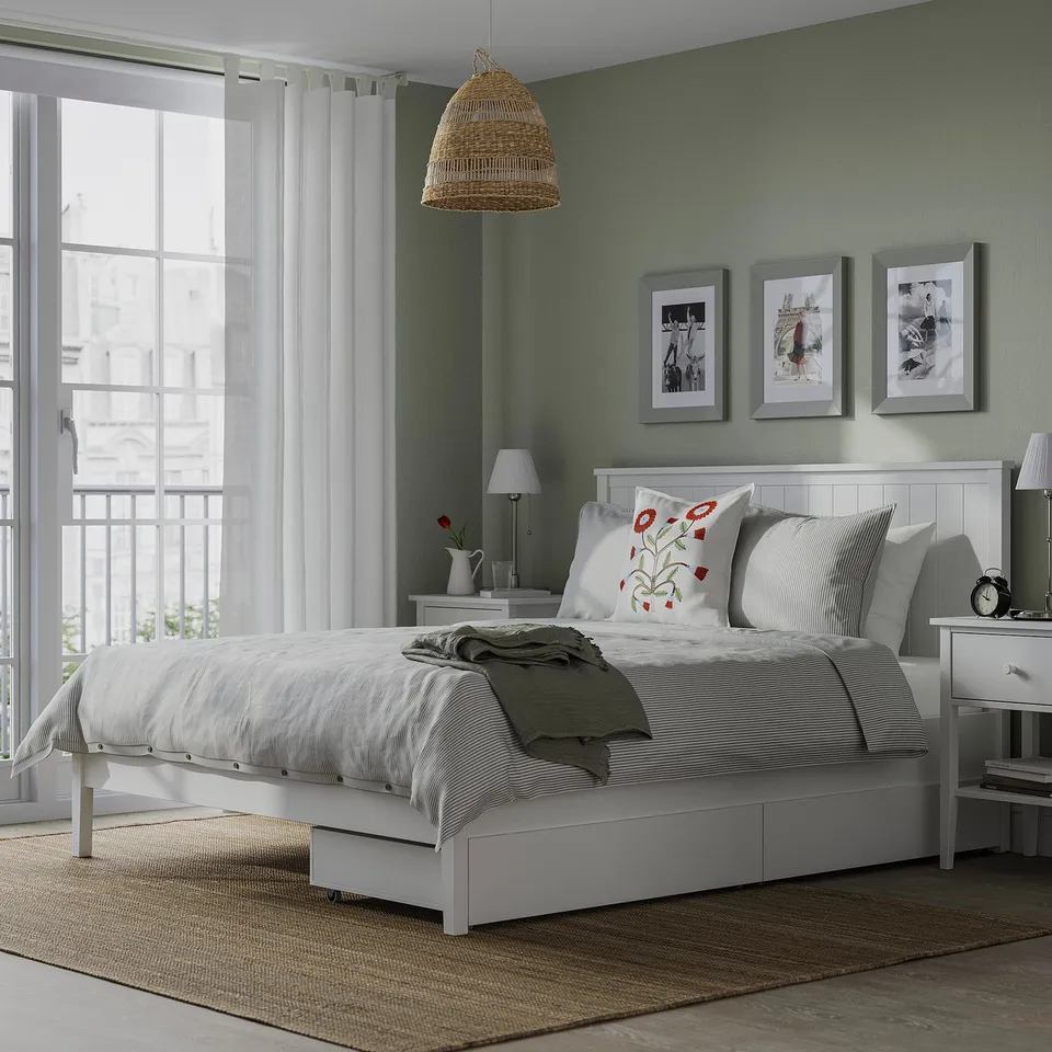 Gullaberry bed, white headboard, drawers, striped linens, floral pillows.