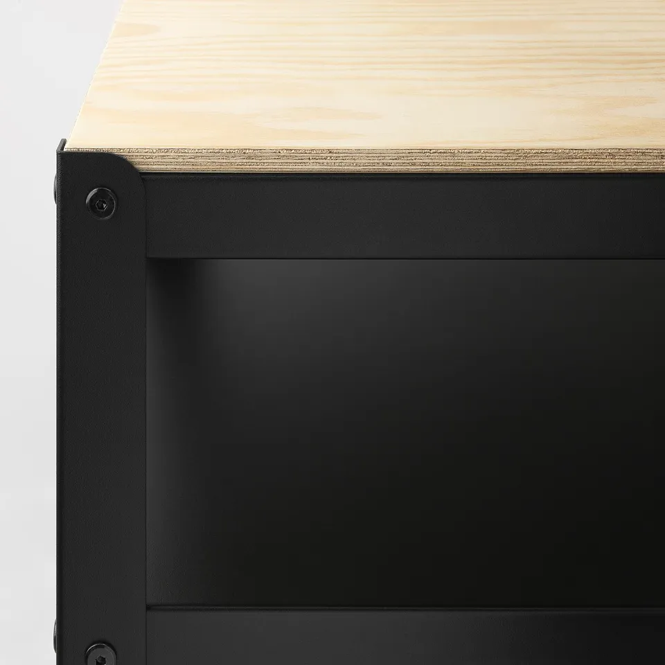 Close-up of robust black metal shelf with wooden top, showcasing sturdy design and craftsmanship.