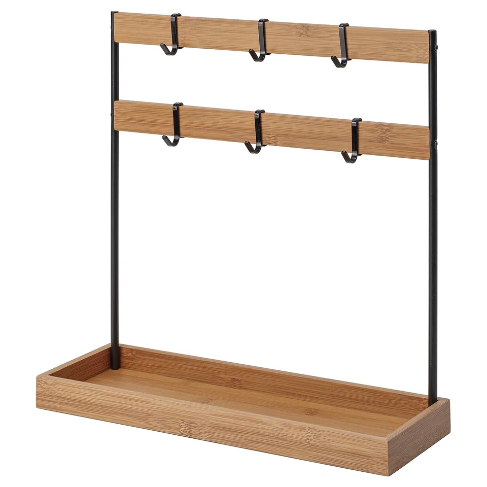 An NÅLBLECKA bamboo kitchen organiser with black metal hooks and shelves, ideal for storing kitchen utensils and spices.