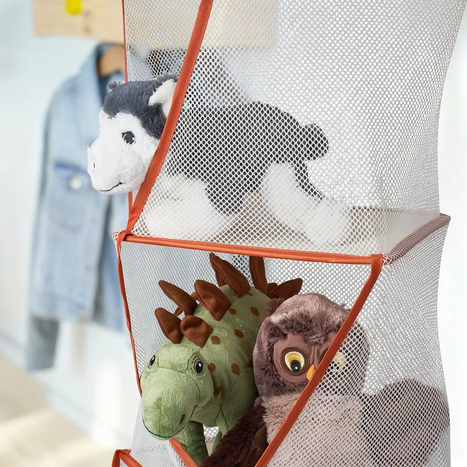 Orange toy organiser with 5 compartments, holding dinosaur, owl, cow toys. Lightweight, foldable, recycled polyester, room-hung.